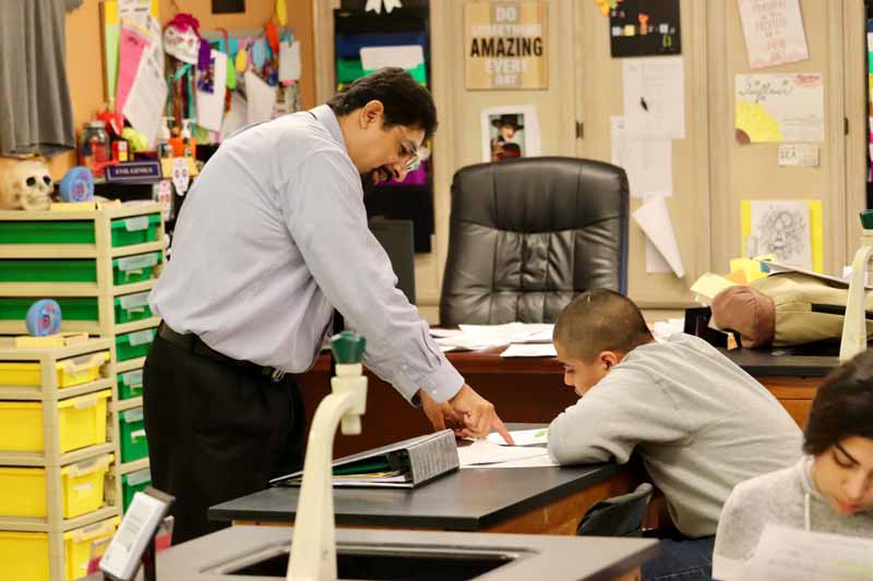 TPHS teacher working with student.